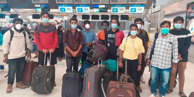 Indian workers rescued after they were lured by agents for fake job opportunities in the information technology sector in Thailand arrive at the airport in Chennai, India on Oct. 5, 2022,