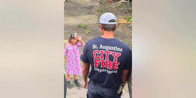 A little girl was rescued by St. Augustine firefighter Hardus Oberholzer during flooding amid Hurricane Ian.