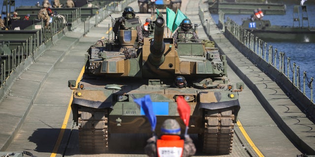 A South Korean soldier leads the tanks taking part in a joint river crossing exercise between South Korean and US troops, in Yeoju, South Korea, October 19, 2022.