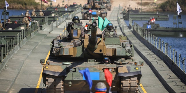 A South Korean soldier leads the tanks taking part in a joint river crossing exercise between South Korean and US troops, in Yeoju, South Korea, October 19, 2022.