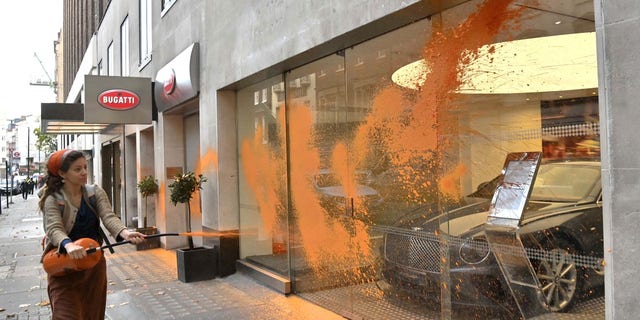 Just Stop Oil protestors vandalize the storefronts of Ferrari, Bugatti and Bentley dealerships in central London Wednesday morning.