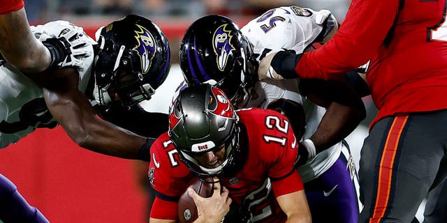 Justin Houston #50 of the Baltimore Ravens sacks Tom Brady #12 of the Tampa Bay Buccaneers during the second quarter at Raymond James Stadium on October 27, 2022 in Tampa, Florida.