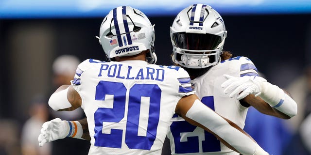 Tony Pollard and Ezekiel Elliott of the Dallas Cowboys embrace during warm-ups against the Washington Commanders, Oct. 2, 2022, in Arlington, Texas.