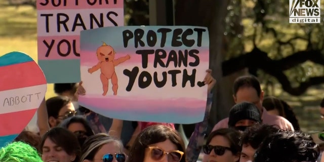 Demonstrators protest in support of rights for transgender youth.