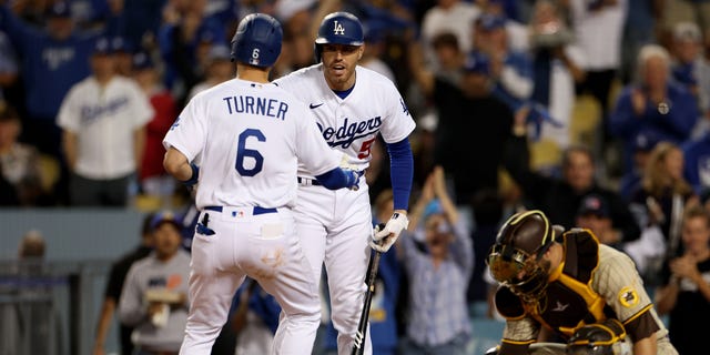 Trea Turner #6 of the Los Angeles Dodgers celebrates his solo home run in the third inning with Freddie Freeman #5 in game two of the National League Division Series against the San Diego Padres at Dodger Stadium on October 12, 2022 in Los Angeles, California.