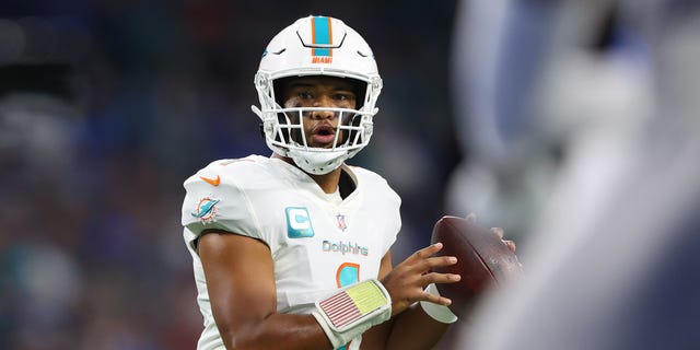 It looks like Tua Tagovailoa #1 of the Miami Dolphins will pass against the Detroit Lions during the first quarter at Ford Field on October 30, 2022, in Detroit, Michigan.