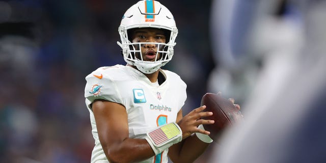 It looks like Tua Tagovailoa #1 of the Miami Dolphins will pass against the Detroit Lions during the first quarter at Ford Field on October 30, 2022, in Detroit, Michigan.