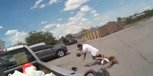 Suspect in Arizona seen fleeing police in a parking lot in Tucson while holding a gun.