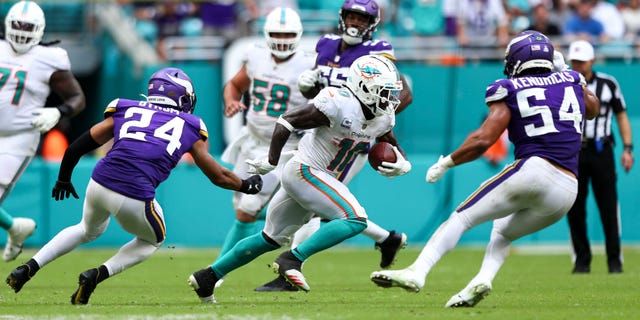 Tyreek Hill #10 of the Miami Dolphins carries the ball after a catch during the fourth quarter of an NFL football game against the Minnesota Vikings at Hard Rock Stadium on October 16, 2022 in Miami Gardens, Florida.