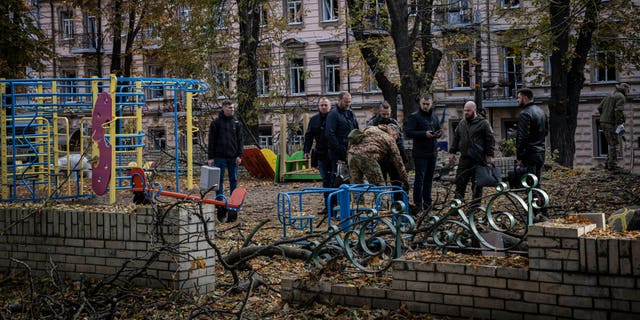 Emergency service personnel attend to the site of a blast next to a childrens playground in a park on October 10, 2022 in Kyiv, Ukraine. This morning's explosions, which came shortly after 8:00 local time, were the largest such attacks in the capital in months. 