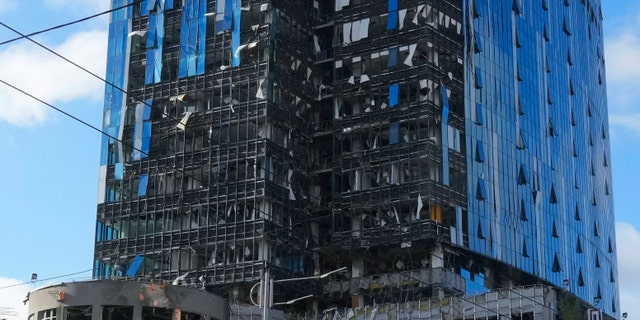 Damaged skyscrapers at the site of a Russian artillery shelling in Kyiv, Ukraine, Monday, October 10, 2022. Two explosions rocked Kyiv early Monday morning after months of relative calm in the Ukrainian capital.  (AP Photo/Efrem Lukatsky)