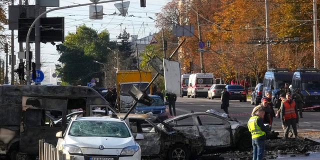 Police inspect the scene of Russian shelling in Kyiv, Ukraine, Monday, Oct. 10, 2022. Two explosions rocked Kyiv early Monday following months of relative calm in the Ukrainian capital. (AP Photo/Efrem Lukatsky)