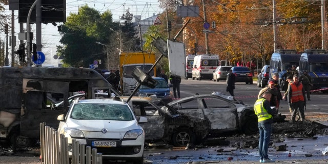 Police inspect the scene of Russian shelling in Kyiv, Ukraine, Monday, Oct. 10, 2022. Two explosions rocked Kyiv early Monday following months of relative calm in the Ukrainian capital. (AP Photo/Efrem Lukatsky)