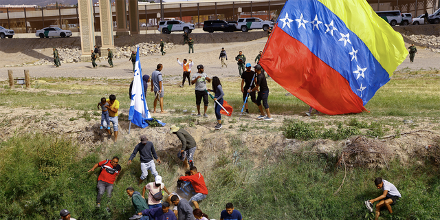 Venezuelan migrants returning to Mexico down the Rio Grande after crossing into the United States run as U.S. Border Patrol agents follow them, as seen from Ciudad Juarez, Mexico, Oct. 31, 2022. 