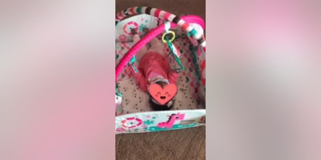 A baby in foster care is the recipient of a One Simple Wish donation (his field is shielded for privacy reasons).