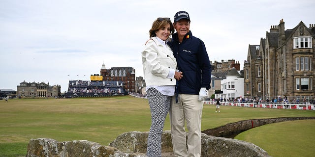 Tom Watson and wife LeslieAnne Wade pose at the Swilcan Bridge on the 18th hole during the Celebration of Champions prior to The 150th Open at St. Andrews Old Course July 11, 2022, in St Andrews, Scotland. 