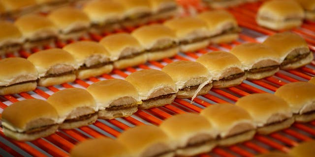 White Castle hamburger Sliders move down a conveyor belt before being frozen, packaged and shipped to grocery stores at the new White Castle Co. Distributing Plant in Vandalia, Ohio, on April 30, 2014. 