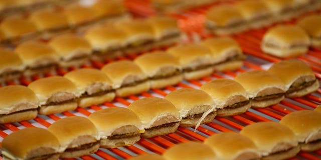 White Castle hamburger Sliders move down a conveyor belt before being frozen, packaged and shipped to grocery stores at the new White Castle Co. Distributing Plant in Vandalia, Ohio, on April 30, 2014.