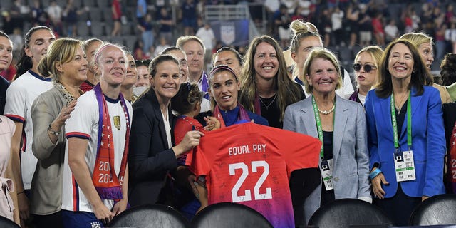 US Soccer Federation president Cindy Parlow Cone, Becky Sauerbrunn and Alex Morgan of the USWNT celebrate following the signing of the Collective Bargaining Agreement after a game between Nigeria and USWNT at Audi Field on September 6, 2022 in Washington, DC.