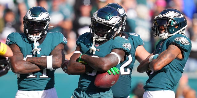 A.J. Brown (11), Zach Pascal (3) and DeVonta Smith (6) of the Philadelphia Eagles celebrate a third-quarter touchdown against the Pittsburgh Steelers at Lincoln Financial Field on Oct. 30, 2022, in Philadelphia, Pennsylvania.