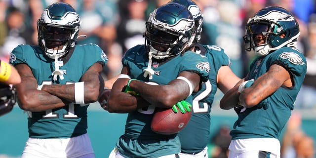 A.J. Brown (11), Zach Pascal (3) and DeVonta Smith (6) of the Philadelphia Eagles celebrate a third-quarter touchdown against the Pittsburgh Steelers at Lincoln Financial Field on Oct. 30, 2022, in Philadelphia, Pennsylvania.