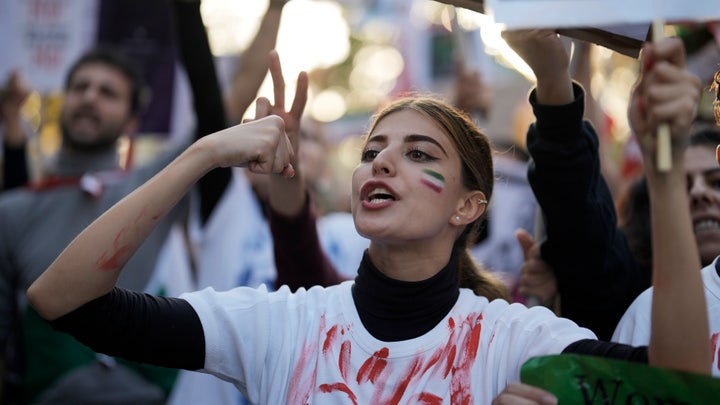 Image of Iranian woman protesting in Tehran