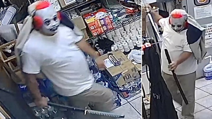 A man in a clown mask robbing a store