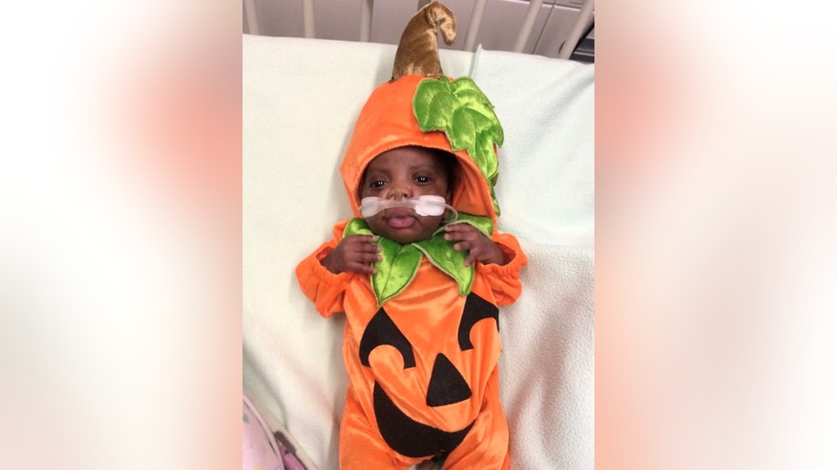 Hospitalized infant dressed as a pumpkin
