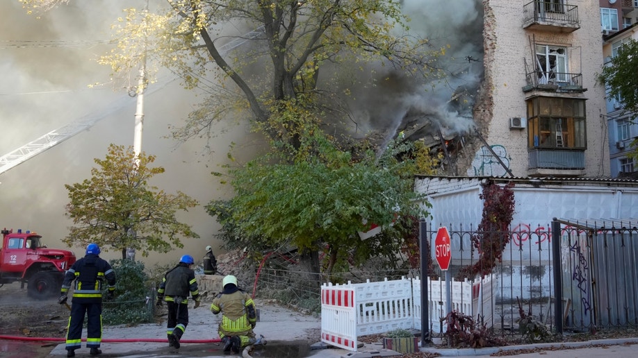 Firefighters near damaged buildings