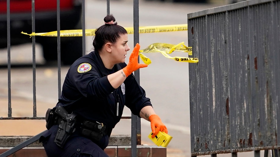 A member of the St. Louis Police Department investigates the scene of a shooting at Central Visual and Performing Arts High School Monday, Oct. 24, 2022, in St. Louis.