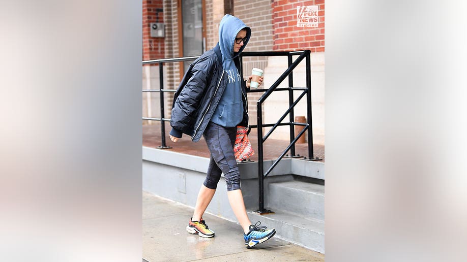 Bridget Moynahan wears hoodie, jacket, and leggings while out in New York City