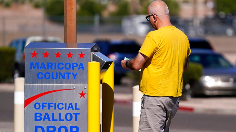 Voter submitting ballot in Arizona elections