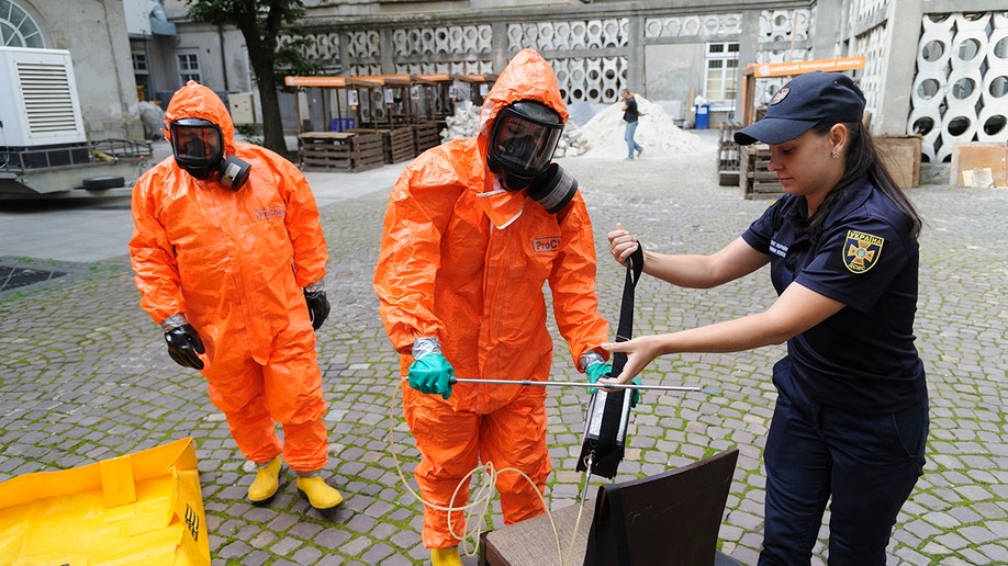 A photo of workers in hazmat suits