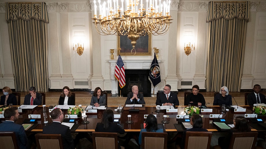 A photo of officials sitting around a table
