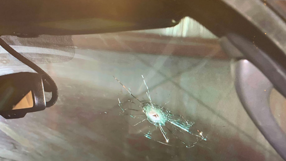Bullet hole in windshield glass