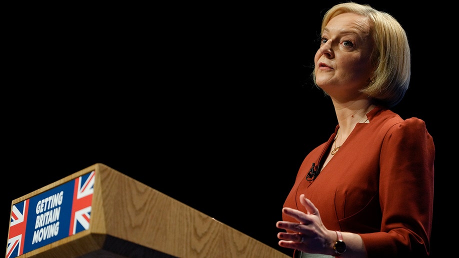 Liz Truss speaking at a podium