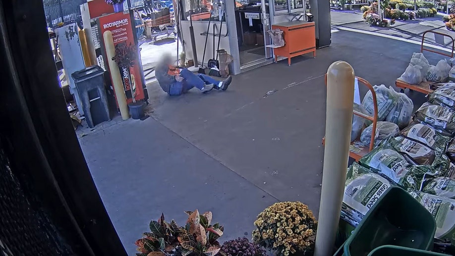 Home Depot worker on ground holding leg