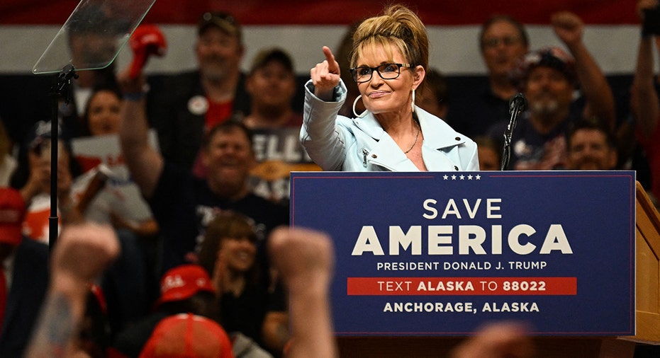 Sarah Palin speaking at an event with former President Donald Trump