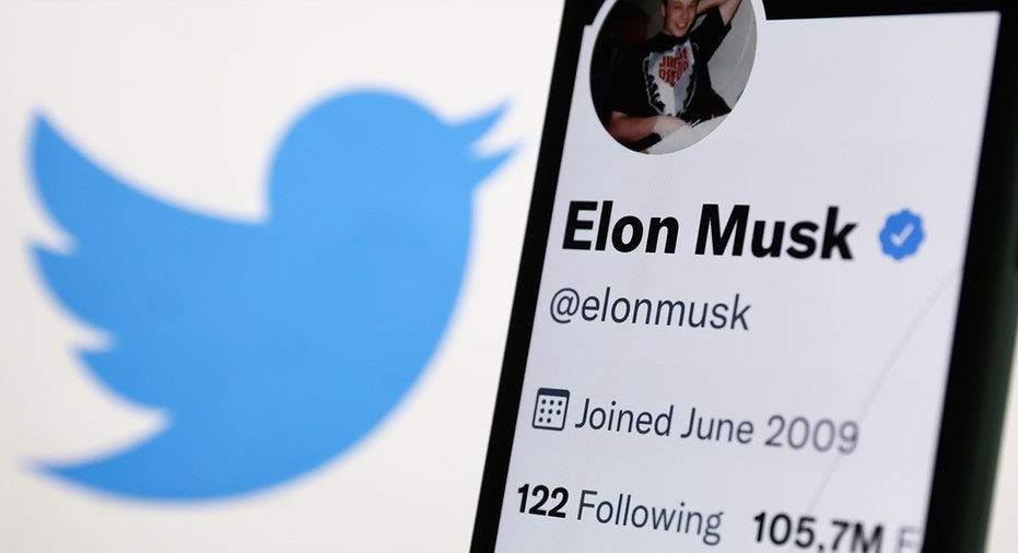 A photo of Elon Musk's Twitter next to the Twitter logo