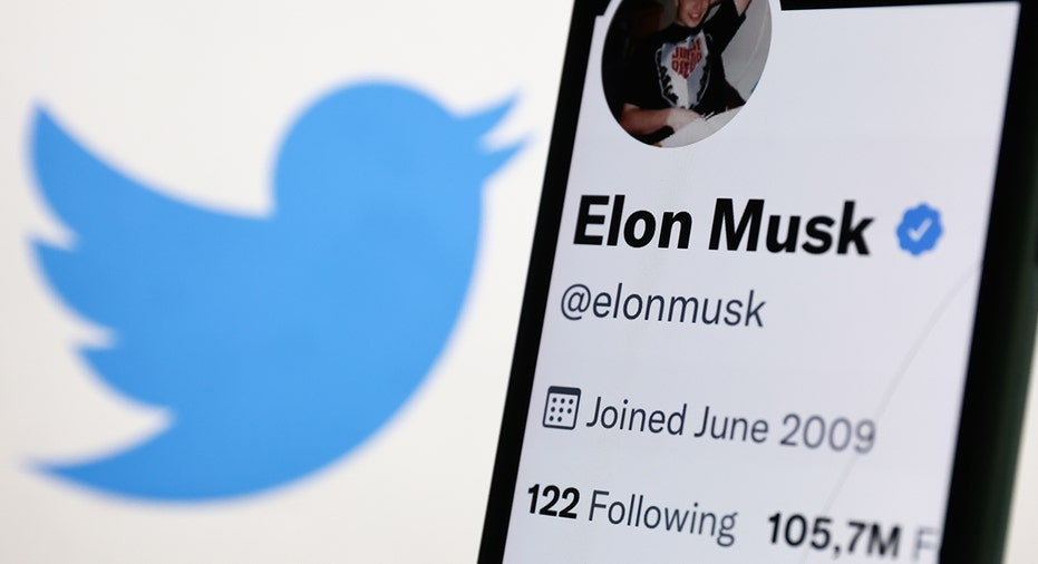 A photo of Elon Musk's Twitter next to the Twitter logo