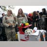 Two girls and a dog dressed in Ghostbuster costumes