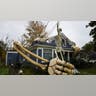 Skeleton figure in yard with giant skeletal arm