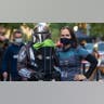 A man, woman and baby dressed in costumes from "The Mandalorian."