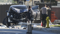 Two investigators stand next to a mangled SUV that struck Los Angeles County sheriffs recruits in Whittier, California, on Nov. 16.