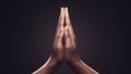 Praying hands with faith in religion and belief in God on dark background. Power of hope or love and devotion. Namaste or Namaskar hands gesture.