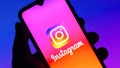 The Instagram logo is seen displayed on a smartphone. Instagram allows users to shake their device to report "bugs," or instances of the app not working properly.