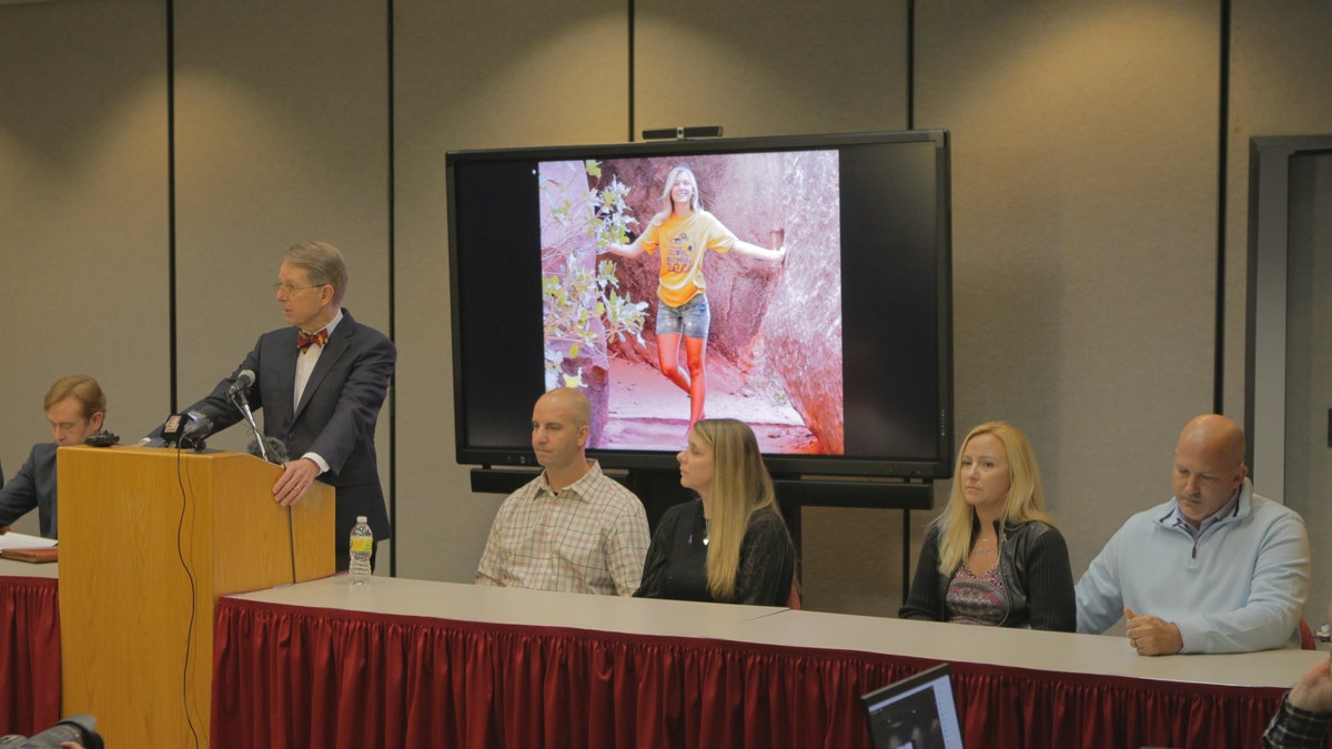 Press conference with a speaker and four people at a table to the right