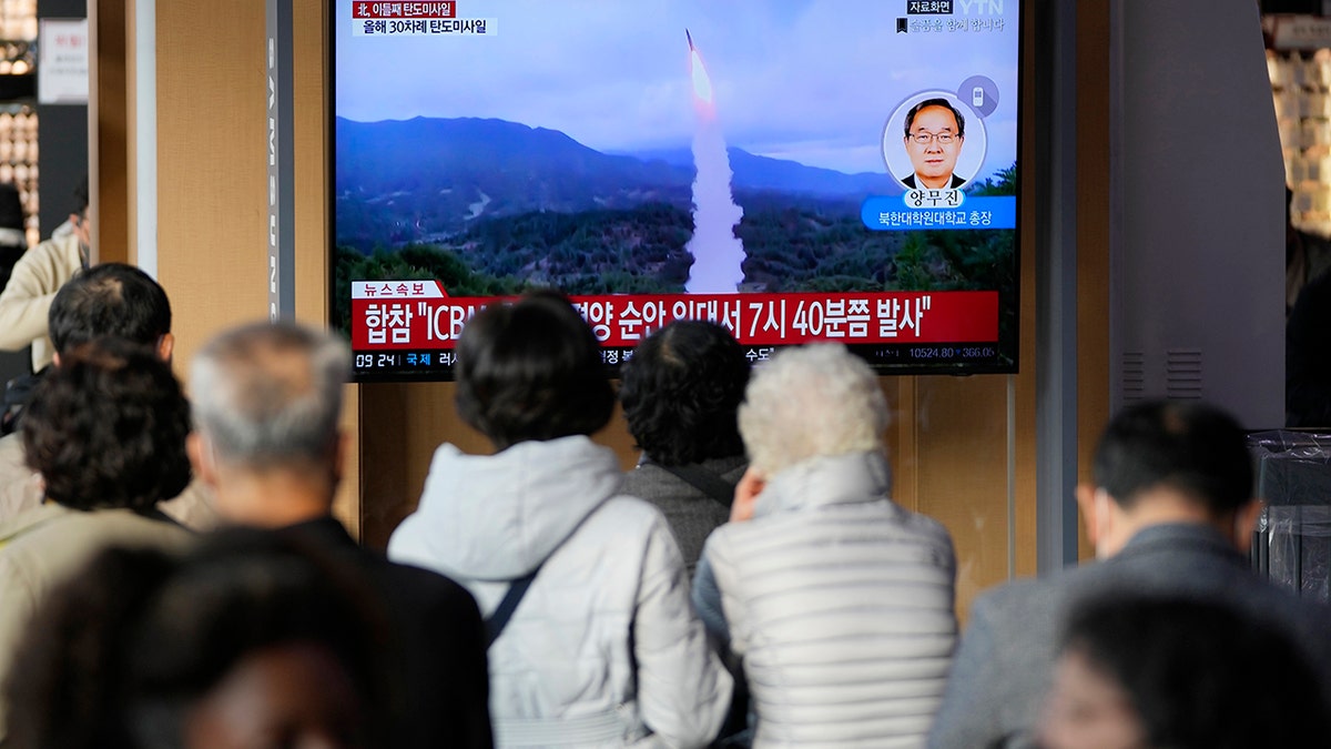 People watching a screen of a missile launch