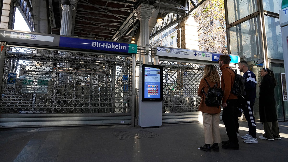 People stand in front of closed French subway station