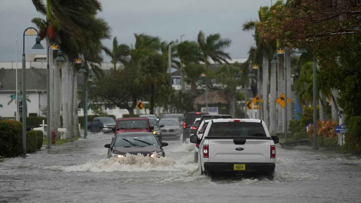 Cars driving through flood cause by Nicole